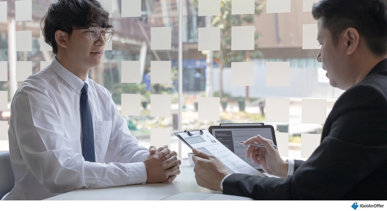 Candidate discussing his resume with an interviewer.