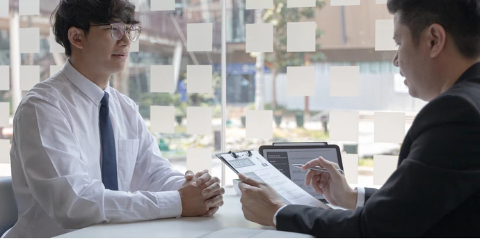 Candidate discussing his resume with an interviewer.