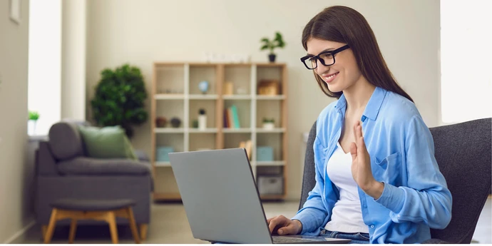 Woman practicing a virtual interview on her laptop from home