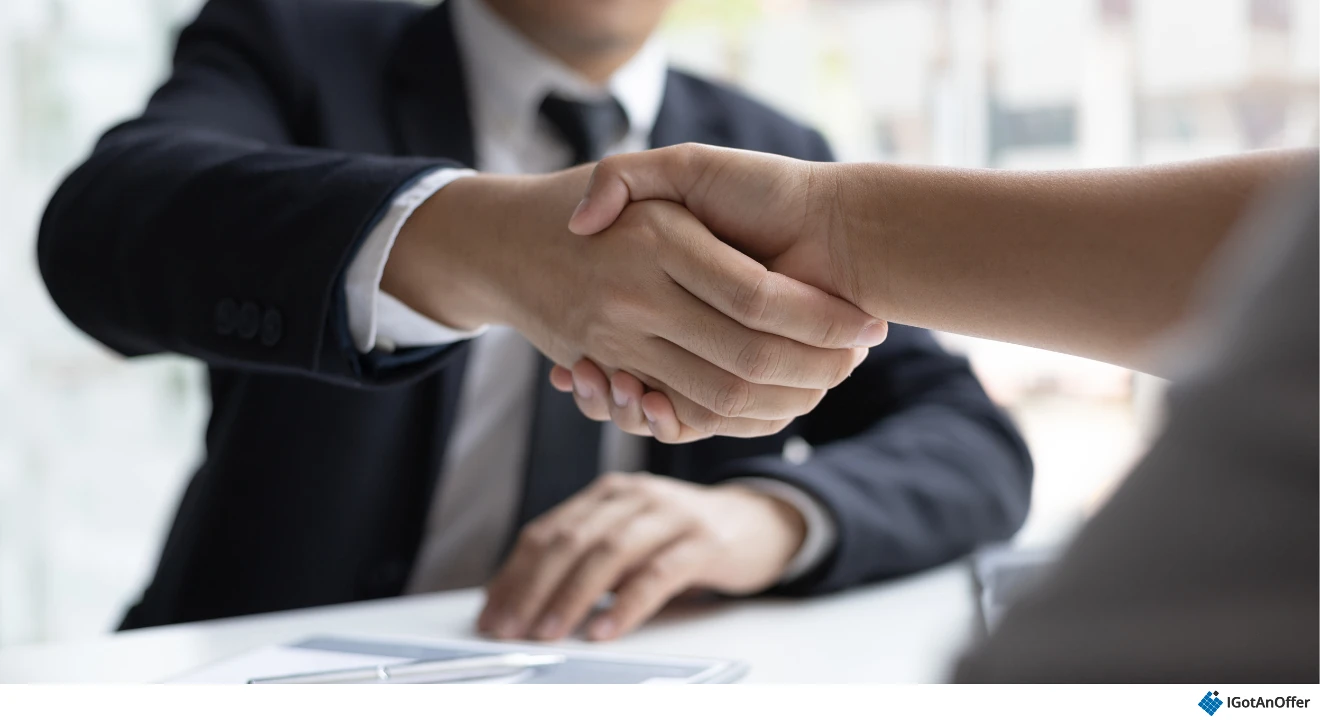 Candidate and interviewer shaking hands.