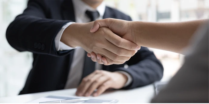 Candidate and interviewer shaking hands.