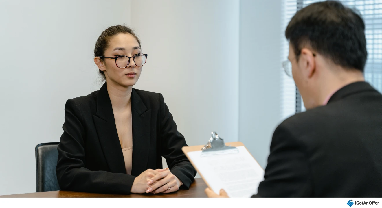 Candidate speaking with an interviewer across a desk.
