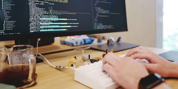 a staff software engineer working in front of a desktop computer