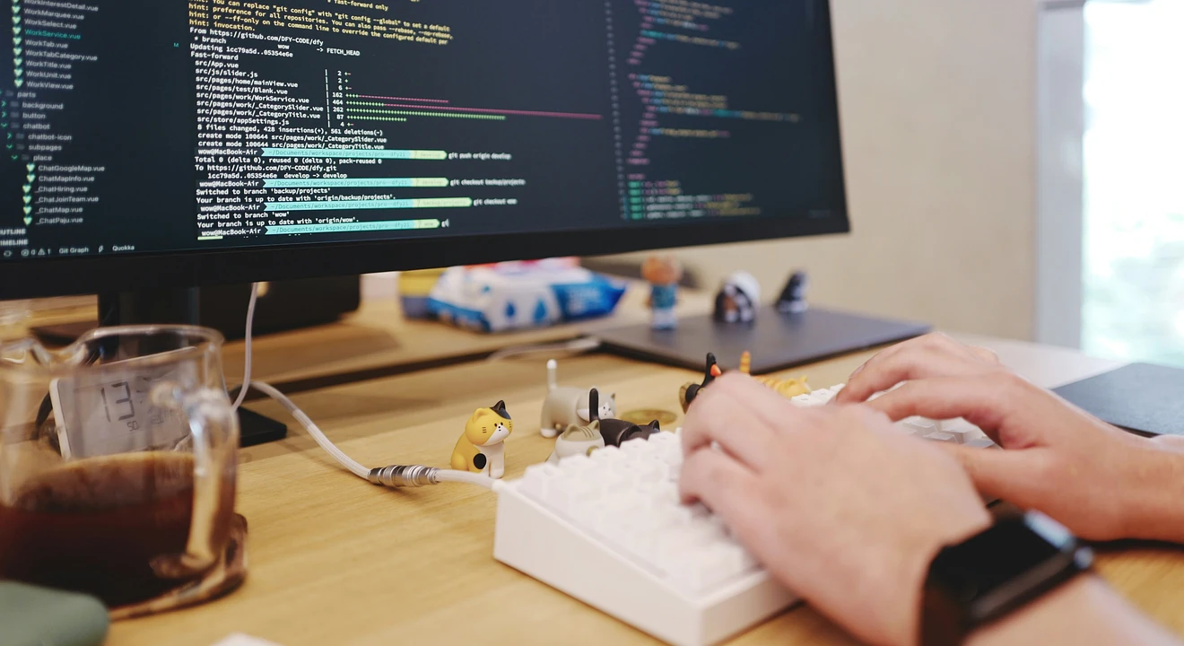 a staff software engineer working in front of a desktop computer