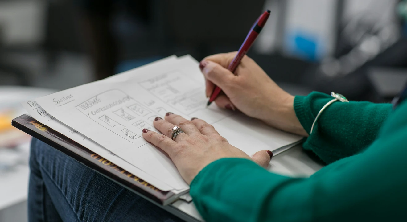 close up of notebook with scribbled outline on how to answer product design questions