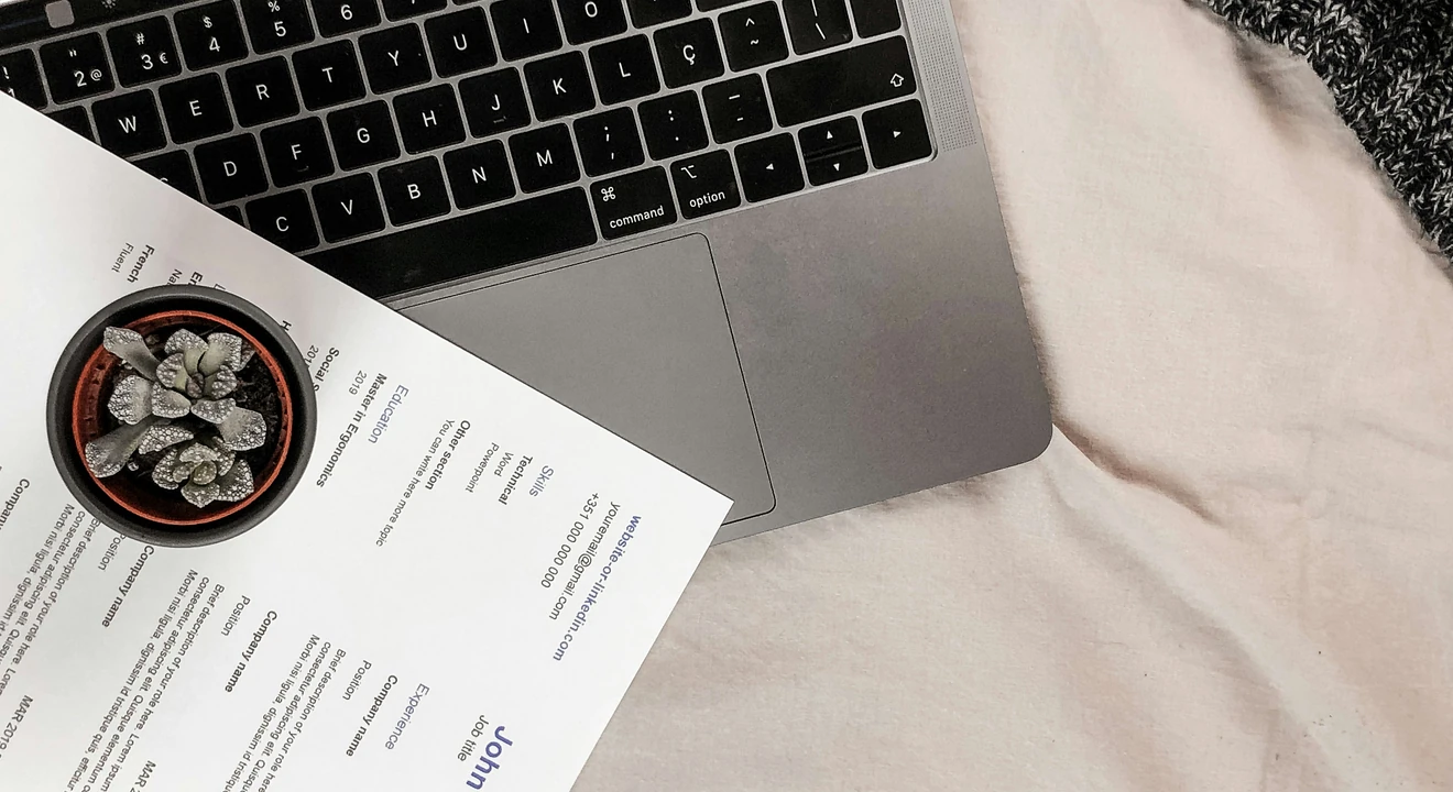white printout resume placed on a laptop