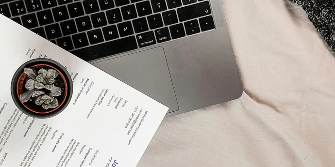 white printout resume placed on a laptop