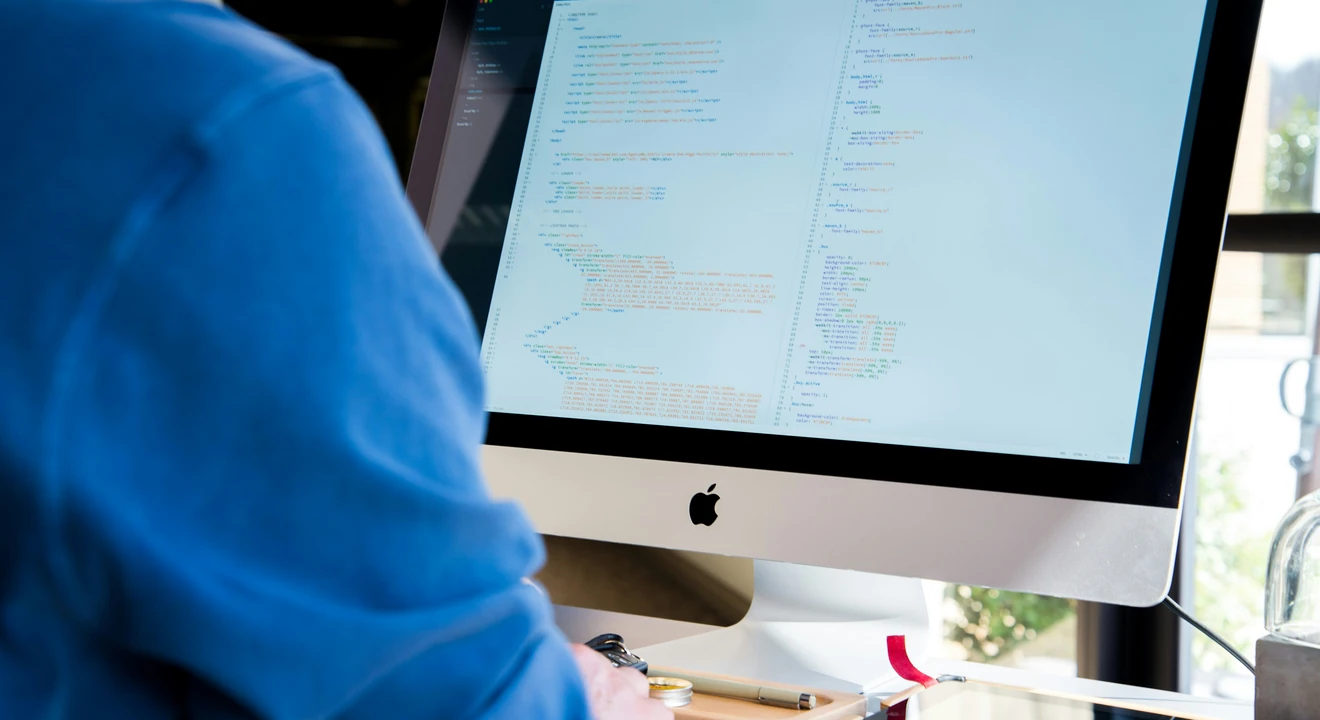 ML engineer working on an iMac
