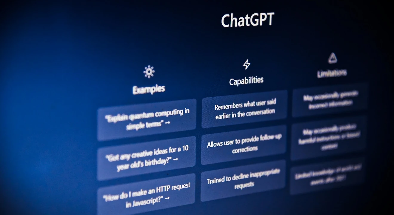 Close-up of the ChatGPT interface showing example prompts, capabilities, and limitations on a dark blue screen