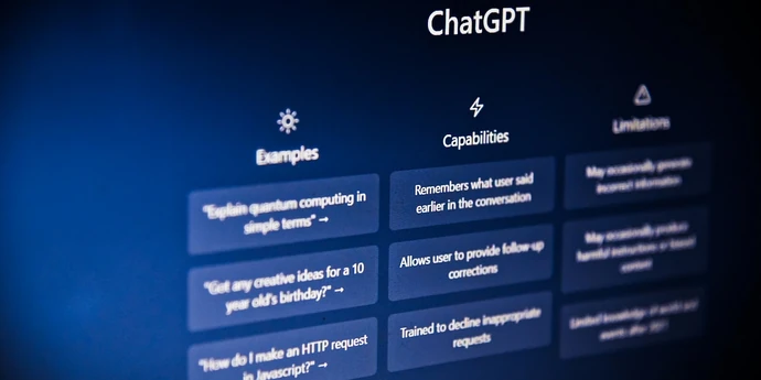 Close-up of the ChatGPT interface showing example prompts, capabilities, and limitations on a dark blue screen