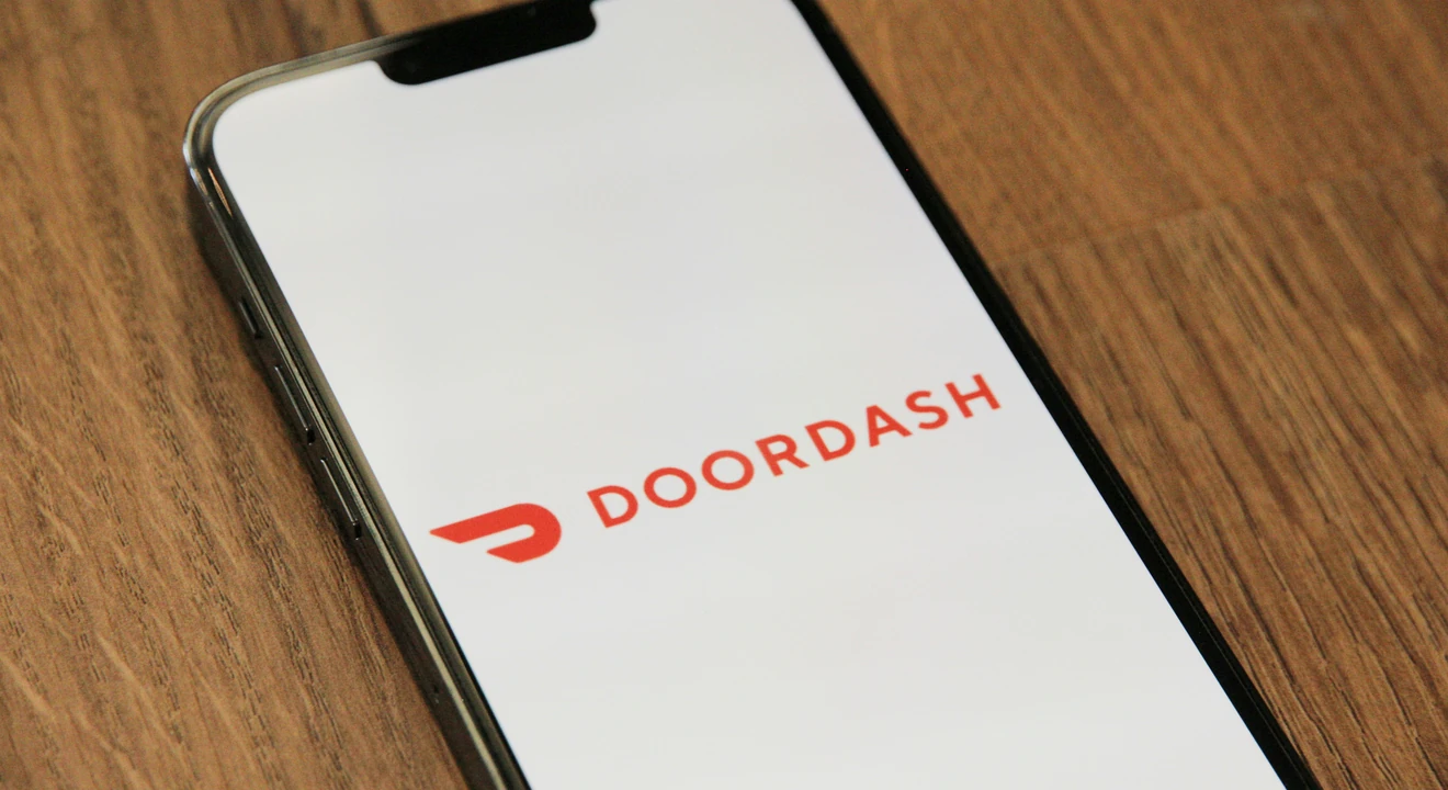 Doordash logo on a phone placed on a table