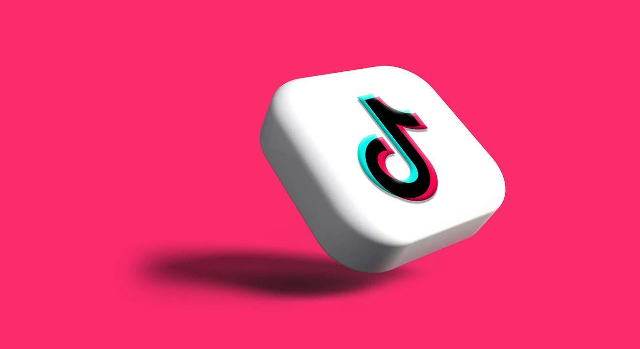 tiktok logo on a cube with a pink background