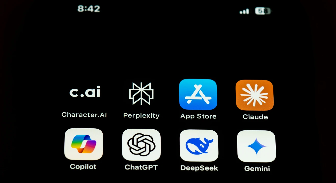 Smartphone screen displaying a grid of AI app icons, including Character.AI, Perplexity, App Store, Claude, Copilot, ChatGPT, DeepSeek, and Gemini, with time and status indicators at the top